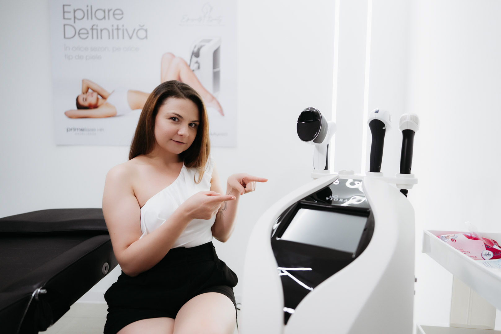 Clienta Episculpt Beauty prezentand aparatul profesional folosit pentru remodelare corporala in Sibiu